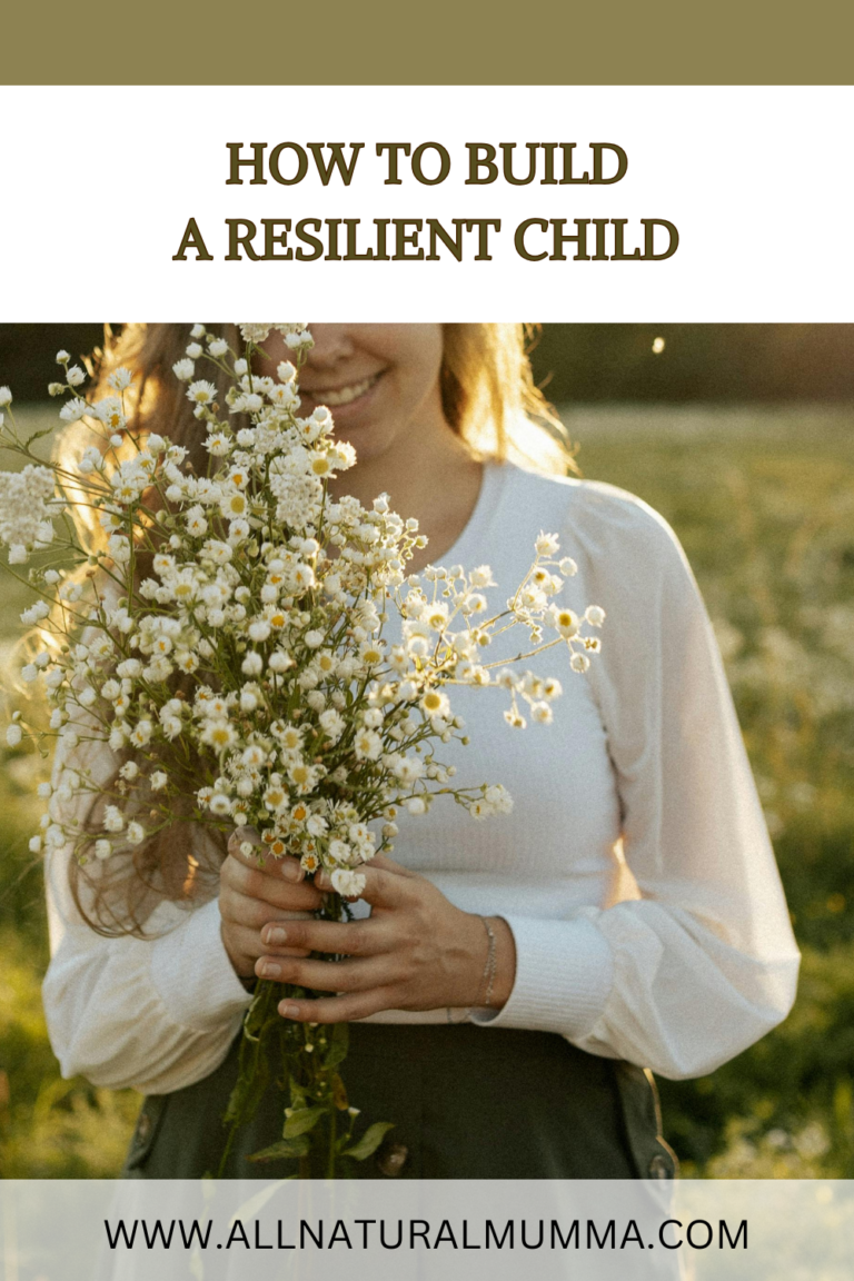 woman in a field holding a bunch of chamomile flowers
