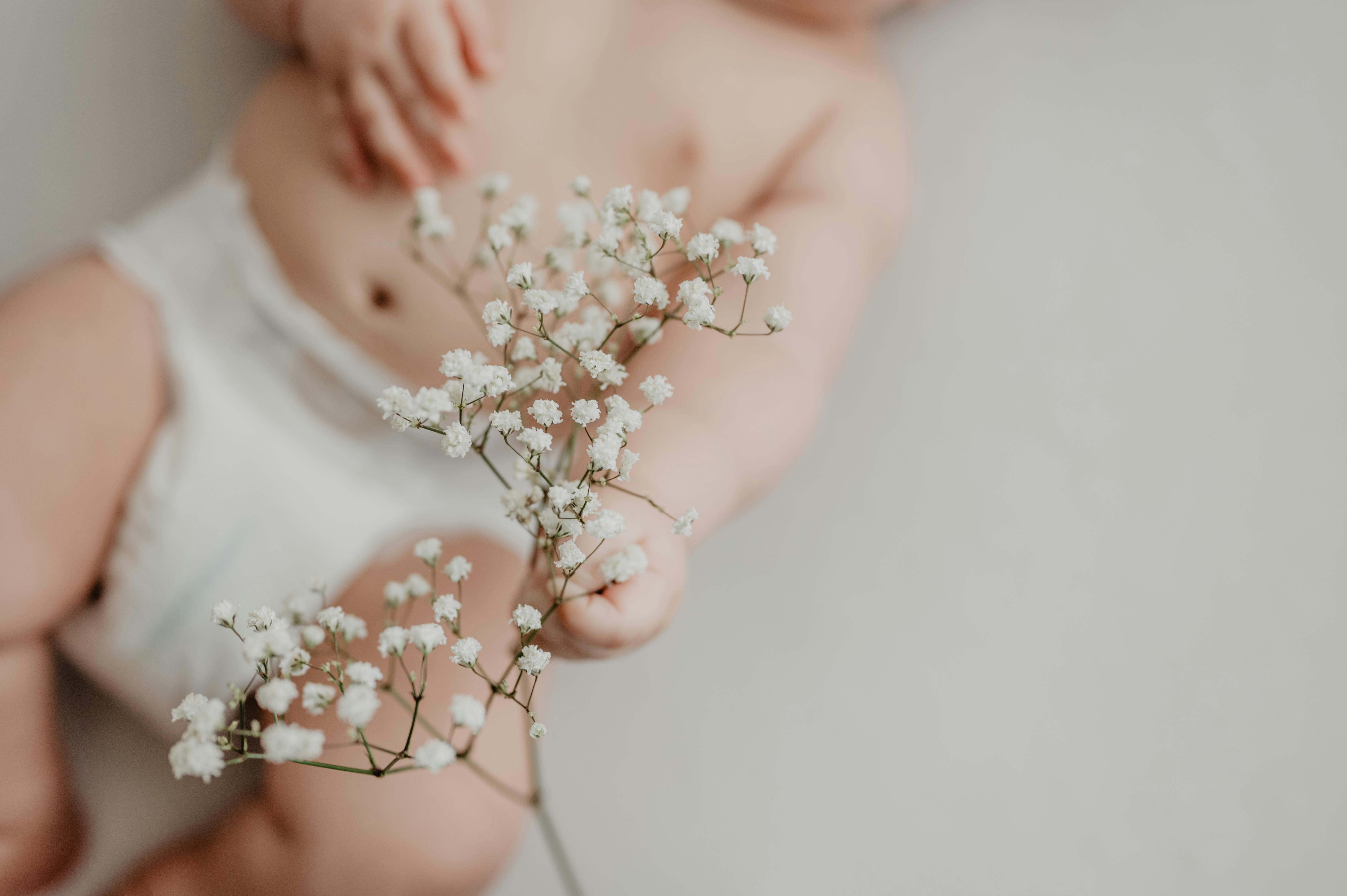 baby holding flowers babys breath